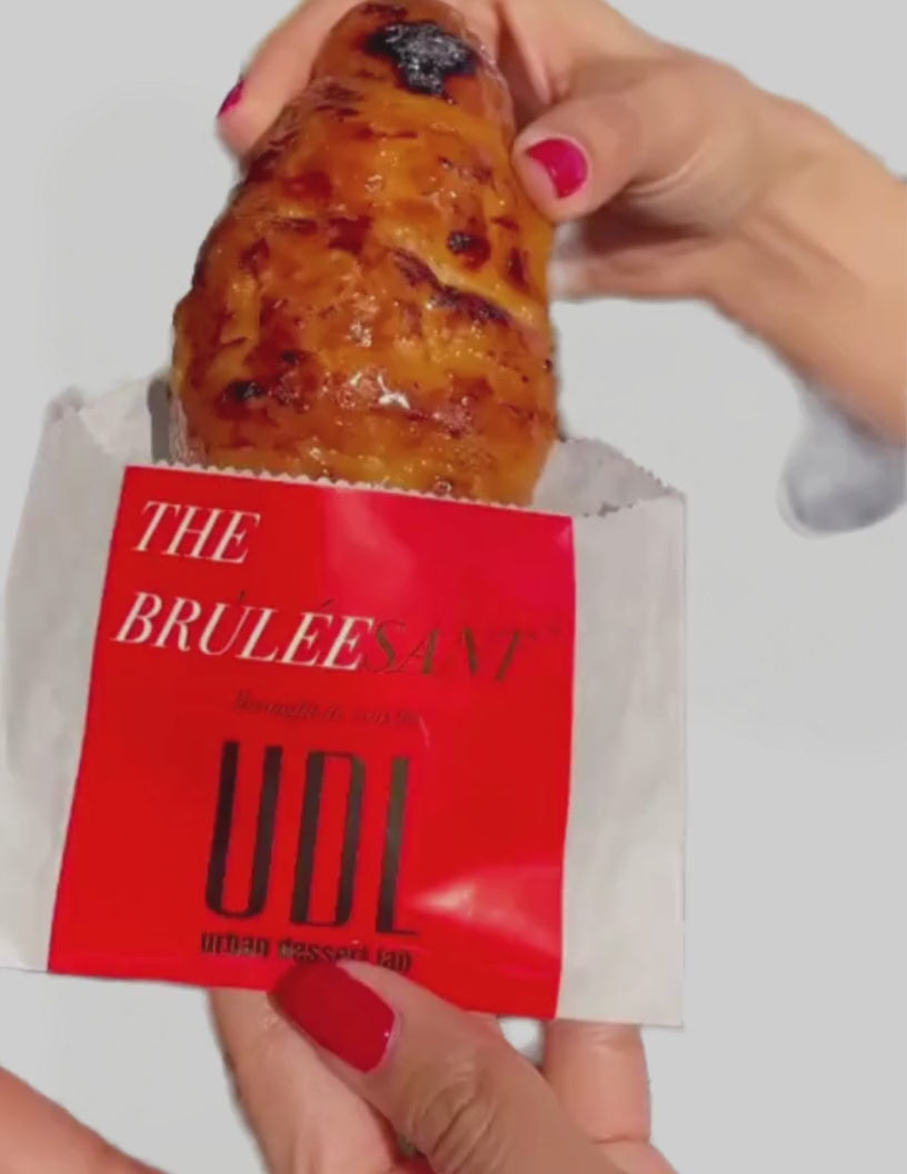 Video of Urban Dessert Lab Bruleed Croissant being pulled out of a bakery bag. 